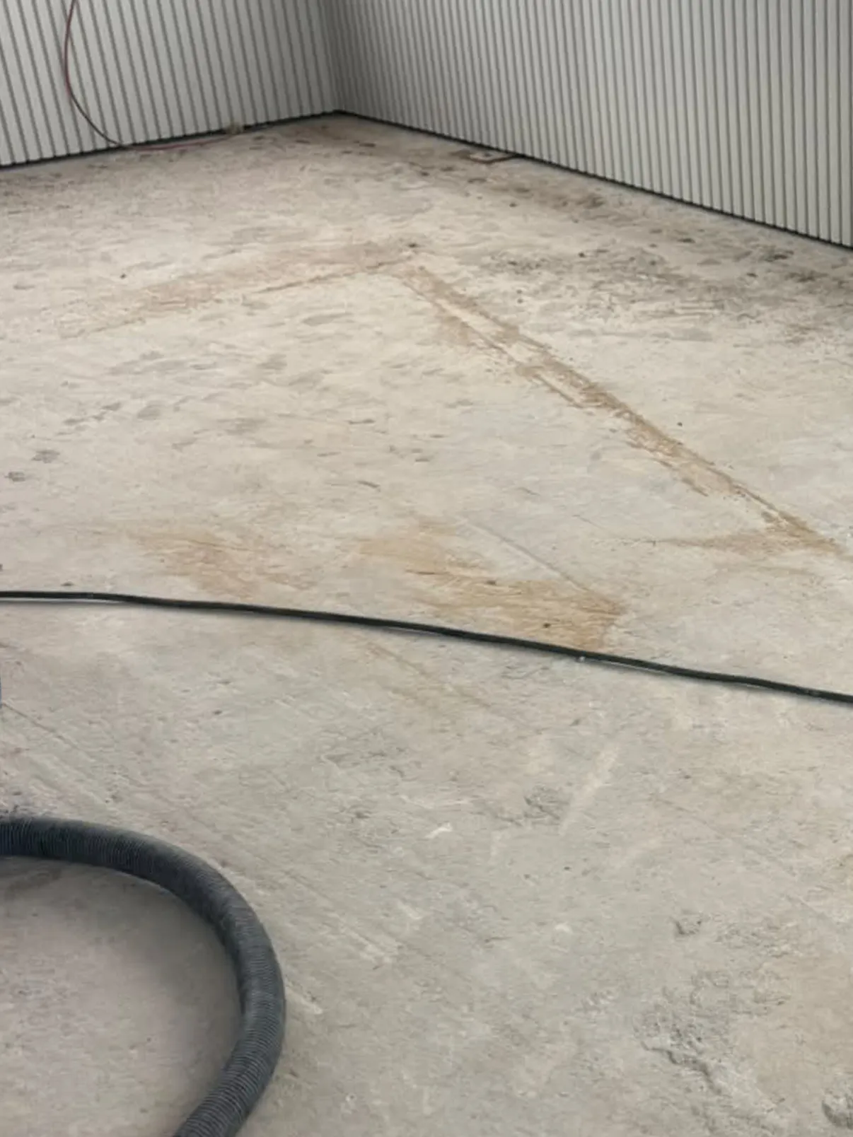 Bare, marked concrete balcony before resurfacing